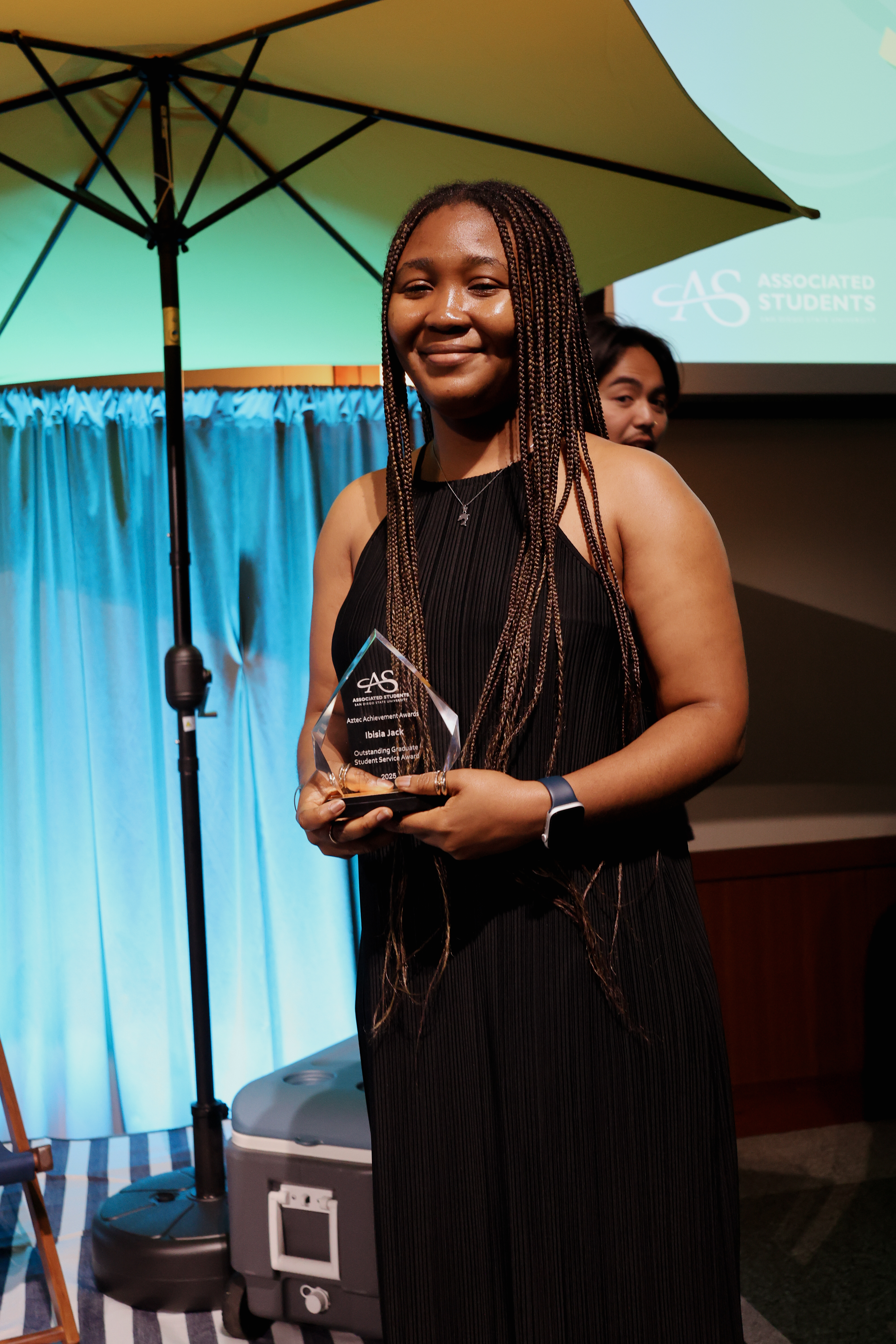 Ibisia accepts the Aztec Achievement Award for dedicated service to the graduate community
